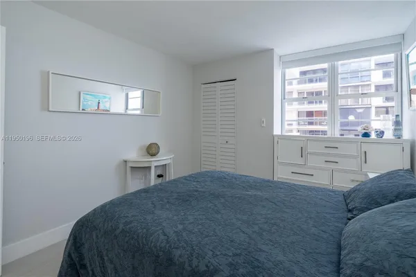a living room with a bed and a window