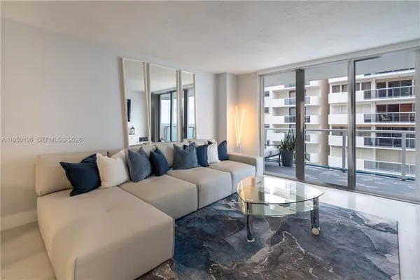 a living room with furniture and a floor to ceiling window