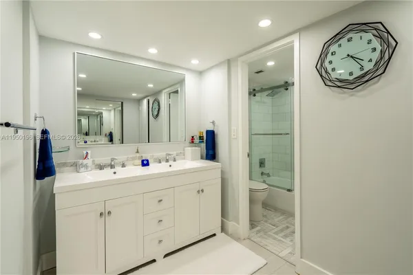 a spacious bathroom with a double vanity sink mirror and toilet