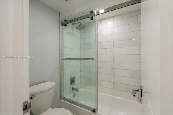 a bathroom with a shower and a toilet