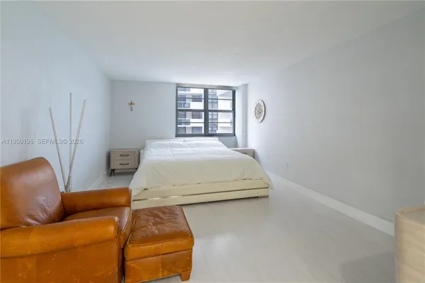 a bedroom with a bed and a couch