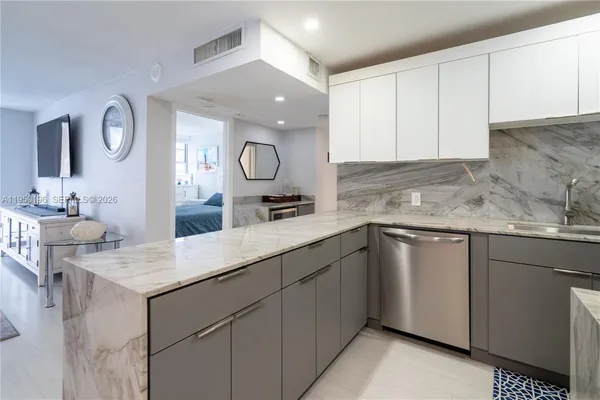 a kitchen with cabinets appliances and a sink