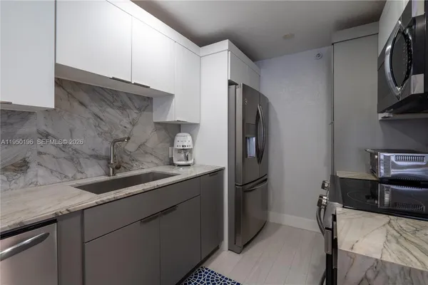a kitchen with stainless steel appliances a refrigerator and a sink