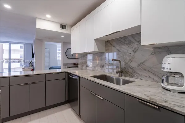 a kitchen with a sink and cabinets