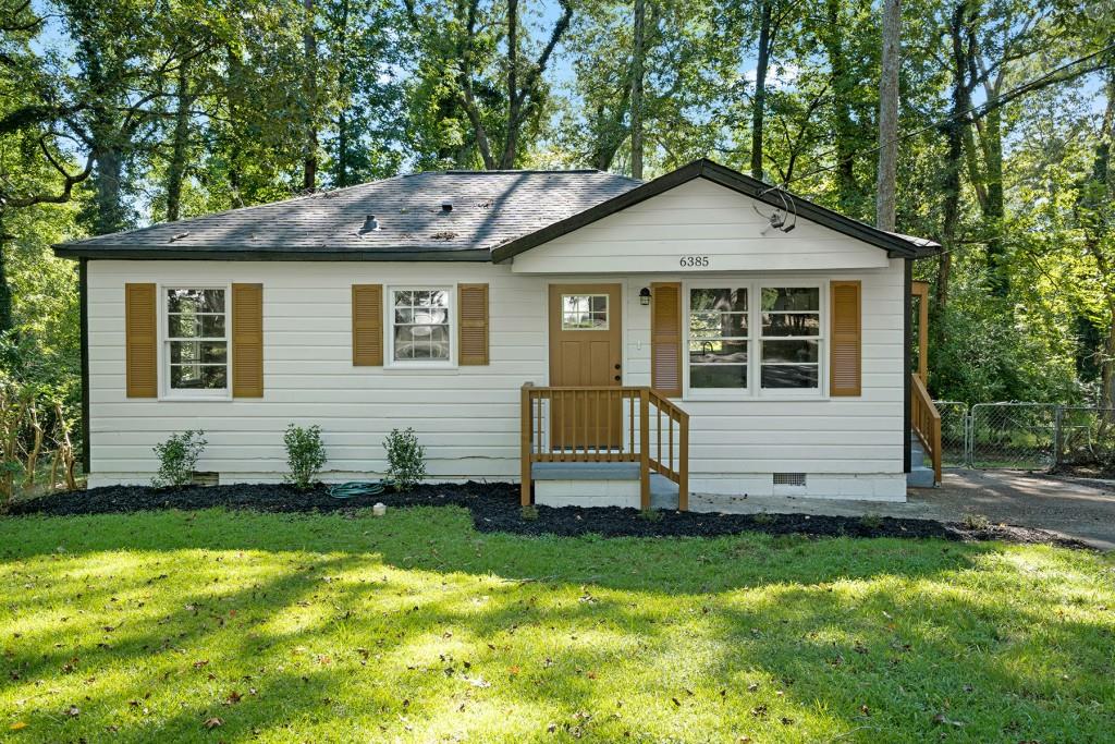 6385 Lobelia Road Southwest Mableton, GA 30126 - Photo 1 of 1 a front view of a house with a yard