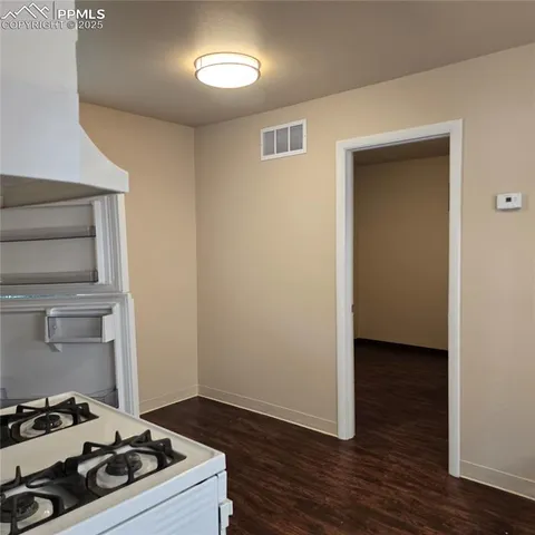 a kitchen with a stove and a refrigerator