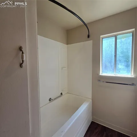 a bathroom with a tub and shower