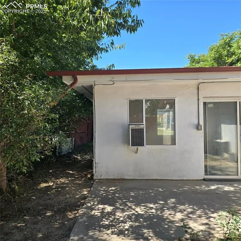 a view of a house with a tree