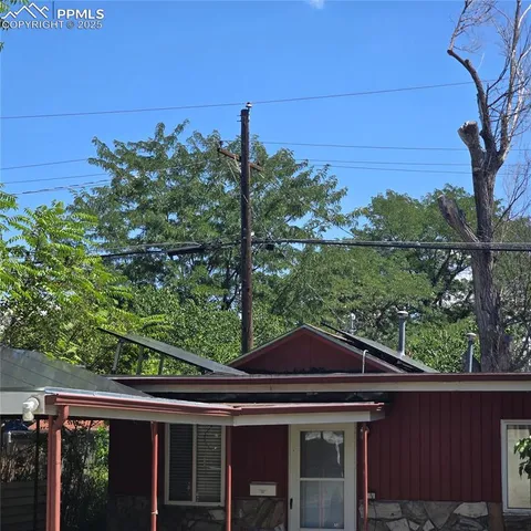 front view of a house with a tree