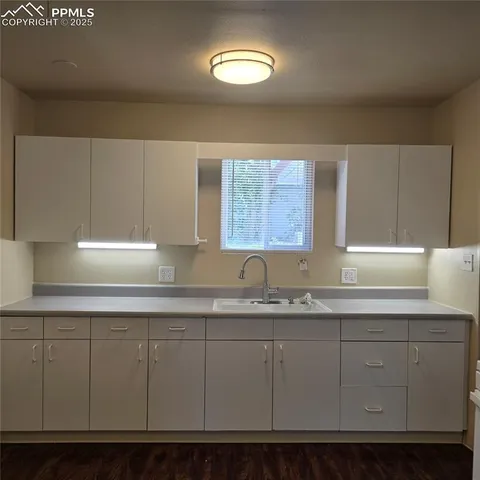 a kitchen with cabinets and window