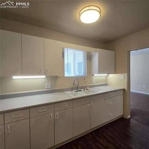 a kitchen with cabinets and window