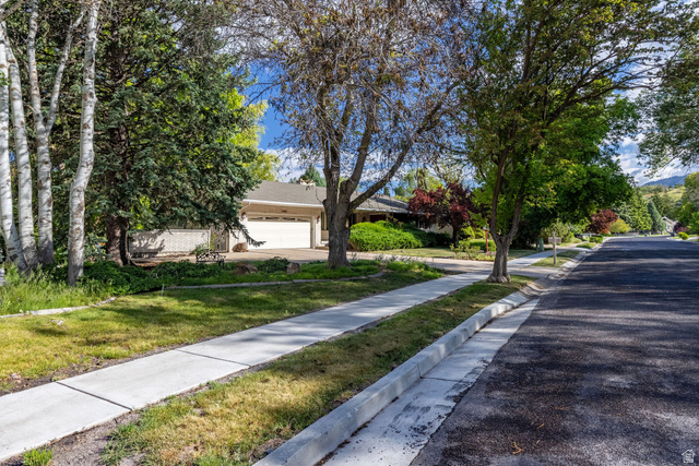 1365 Sumac Drive Logan, UT 84321 - Photo 5 of 66 Residential streetscape featuring a concrete sidewalk and asphalt roadway