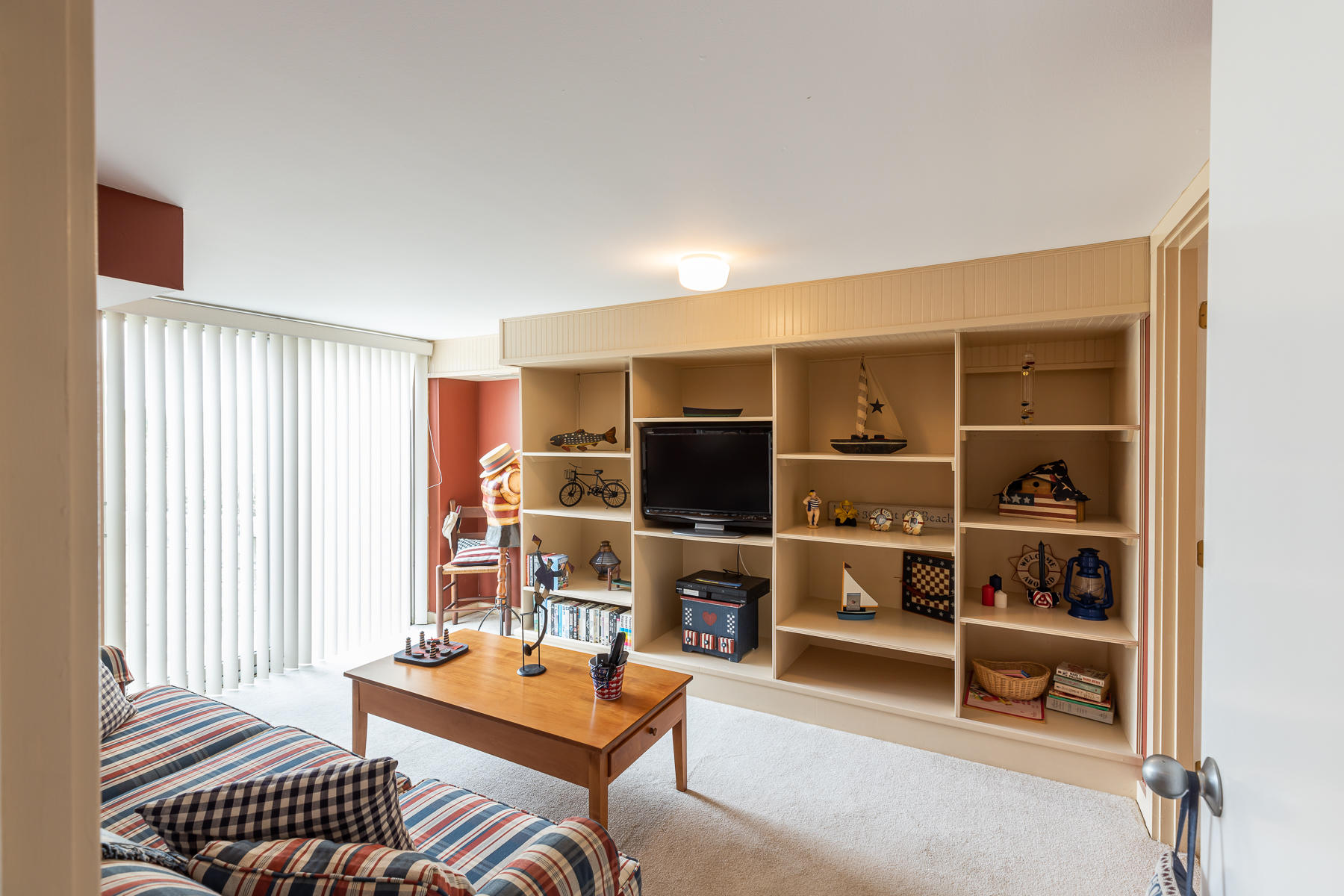315 Phillips Road Sandwich, MA 02563 - Photo 21 of 30 a living room with furniture a flat screen tv and a window