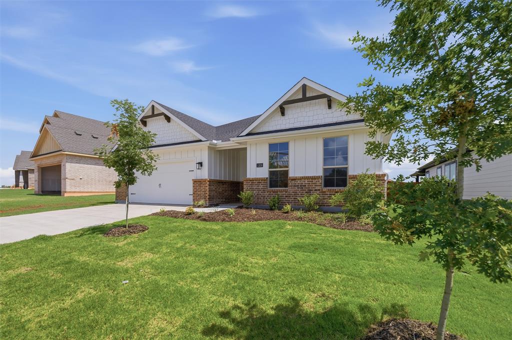 1209 Colca Drive Springtown, TX 76082 - Photo 4 of 24 Contemporary home exterior featuring white vertical siding, brick accents, and dark trim details