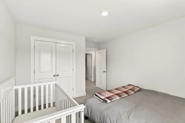 a spacious bedroom with a bed and a couch