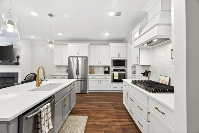 a kitchen that has a sink and a stove