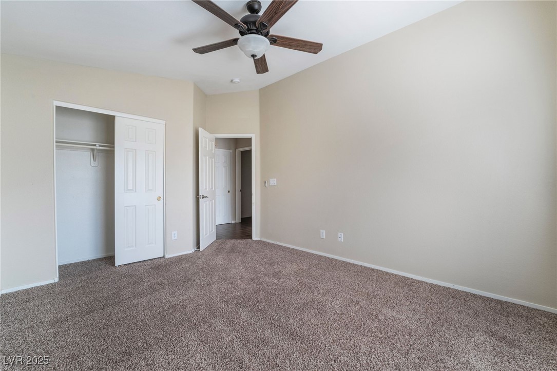 1570 Rusty Ridge Lane Henderson, NV 89002 - Photo 33 of 35 Unfurnished bedroom with a closet, baseboards, a ceiling fan, and carpet