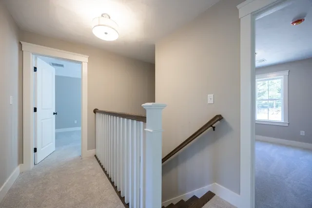 a view of a hallway view with wooden floor and staircase