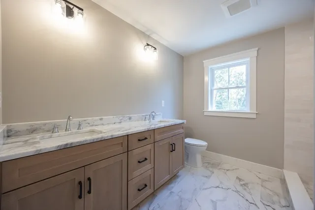 a bathroom with a granite countertop sink a shower and a mirror