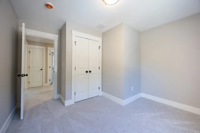 a bathroom with a granite countertop sink a mirror and a toilet