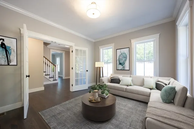 a living room with furniture potted plant and window