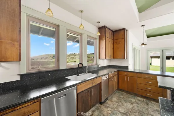 a open kitchen with stainless steel appliances granite countertop a sink a stove and a refrigerator