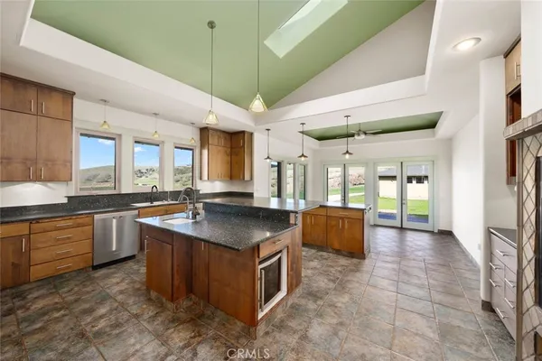 a kitchen with stainless steel appliances granite countertop a stove and a refrigerator