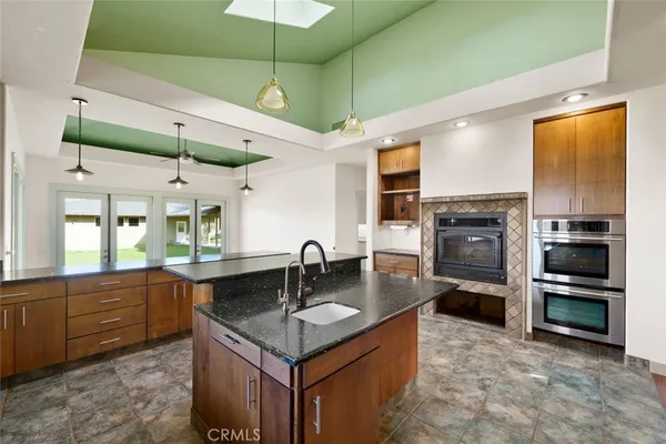 a large kitchen with stainless steel appliances granite countertop a stove and cabinets