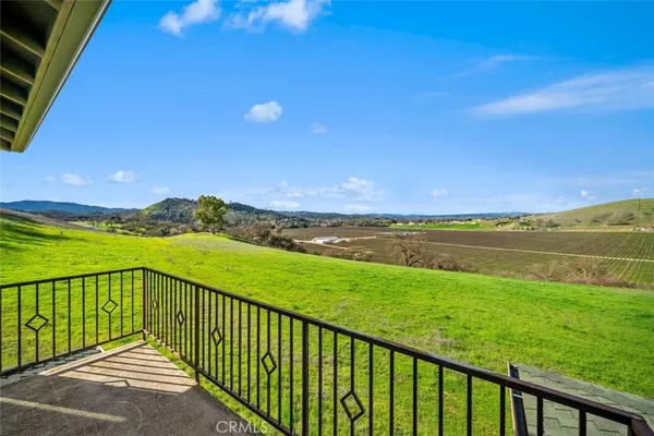 a view of a field with an ocean