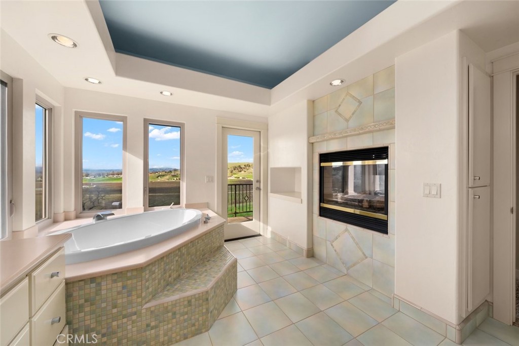 5840 Rocky Canyon Road Atascadero, CA 93422 - Photo 26 of 74 a spacious bedroom with a bed and glass windows