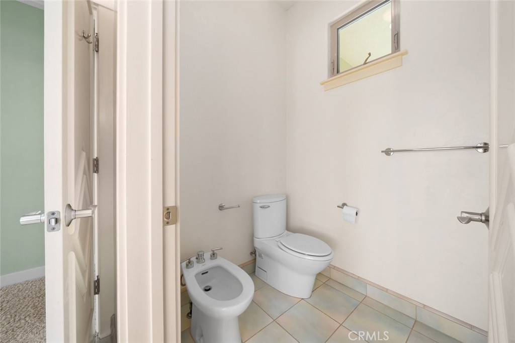 5840 Rocky Canyon Road Atascadero, CA 93422 - Photo 29 of 74 a bathroom with a granite countertop toilet and a sink