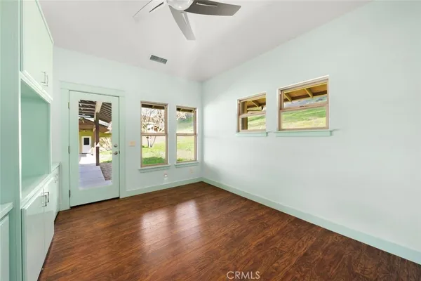 a view of a kitchen with wooden floor and a sink