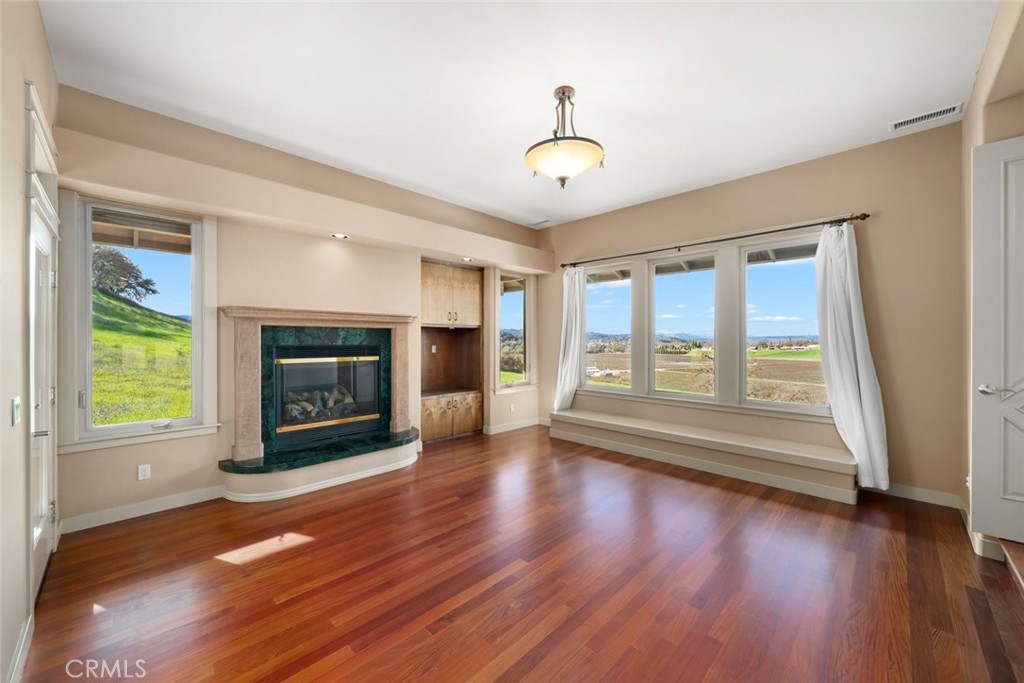 5840 Rocky Canyon Road Atascadero, CA 93422 - Photo 5 of 74 a view of an empty room with wooden floor fireplace and a window