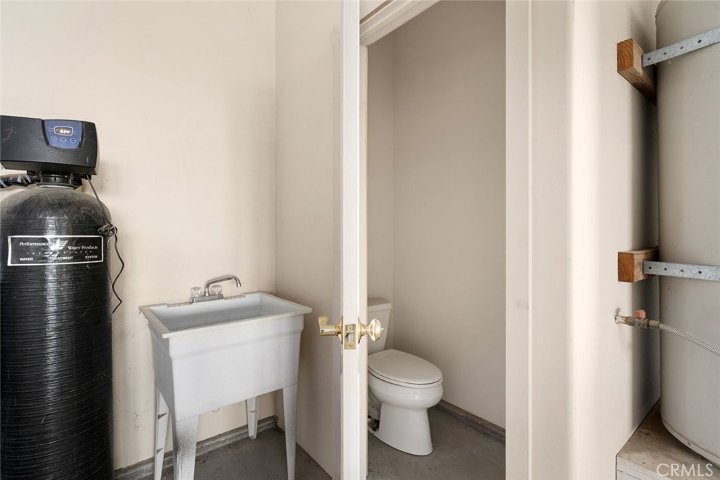 5840 Rocky Canyon Road Atascadero, CA 93422 - Photo 57 of 74 a bathroom with a toilet sink and mirror