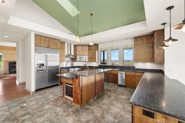 a large kitchen with a sink and large window