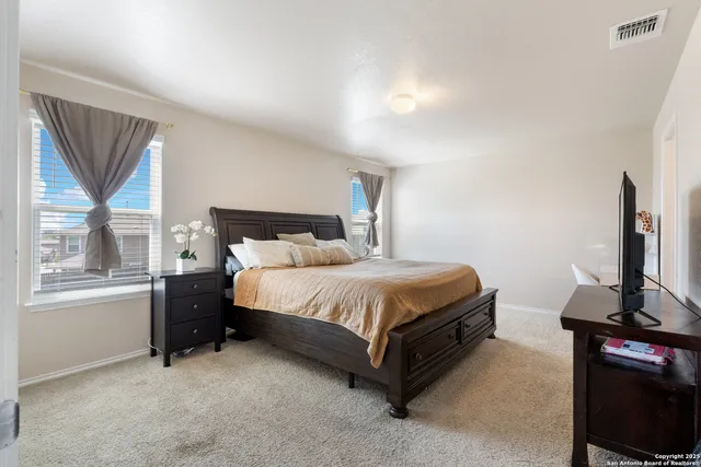 a bed sitting in a room next to a window