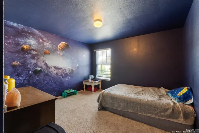 a bedroom with a bed and window