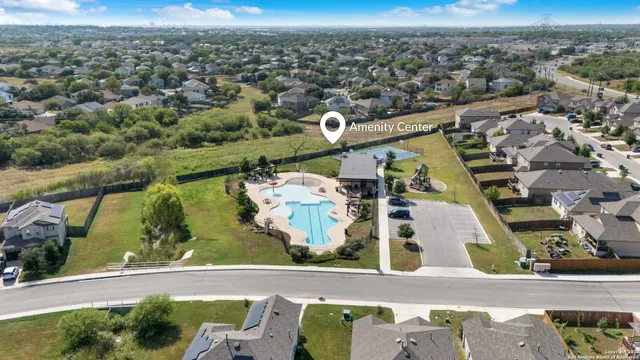 an aerial view of residential houses with outdoor space and city view
