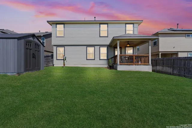 a view of a house with a yard and sitting area