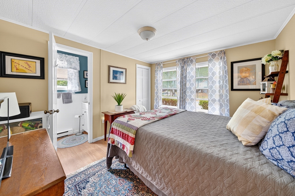 32 Windswept Road Wareham, MA 02576 - Photo 13 of 39 a bedroom with a bed and wooden floor
