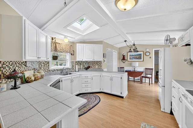 a kitchen with cabinets a sink and appliances