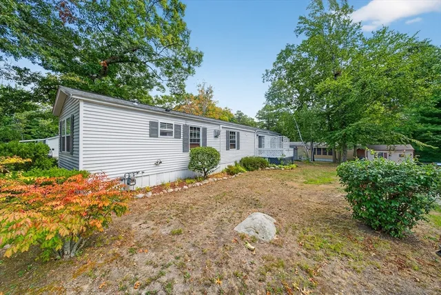 a backyard of a house with plants and trees