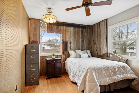 a bedroom with a bed and a chandelier
