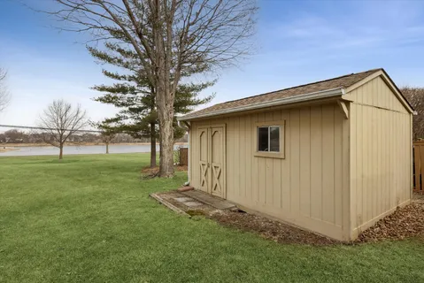 a backyard of a house with lots of green space and fountain