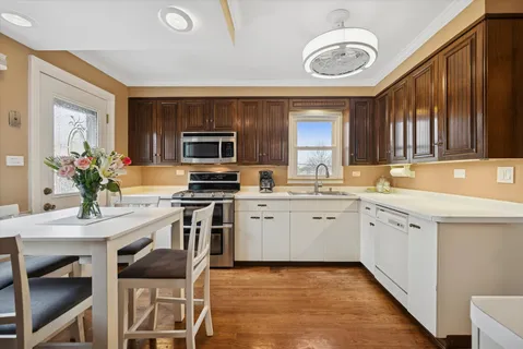 a kitchen with a sink stainless steel appliances and cabinets