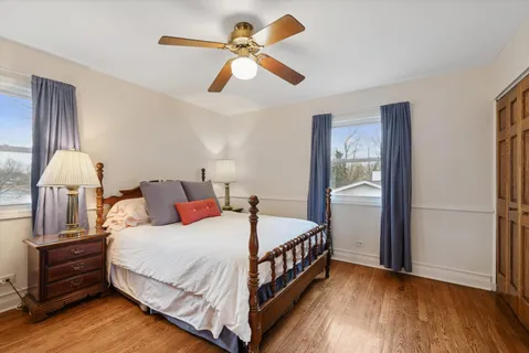 a bedroom with bed and wooden floor