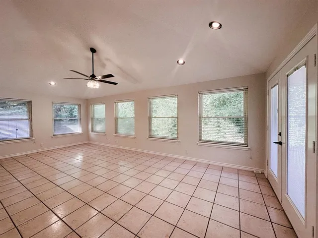 a view of a livingroom with a ceiling fan and window