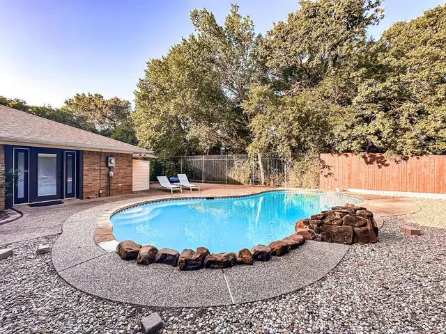 a view of a house with swimming pool and sitting area