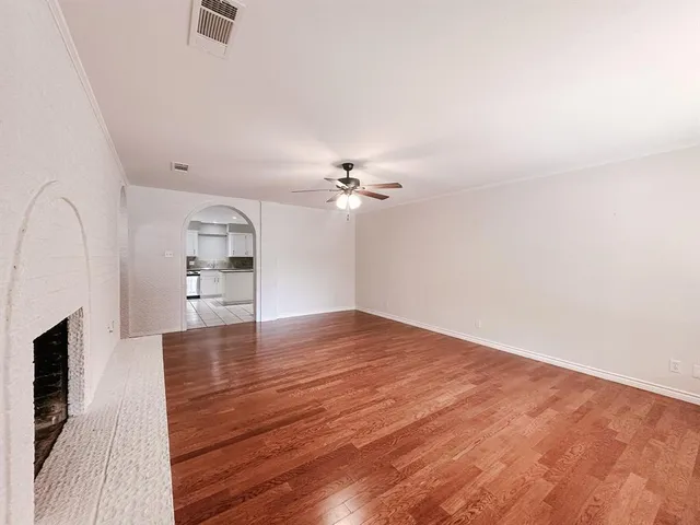 a view of a kitchen with wooden floor and a sink