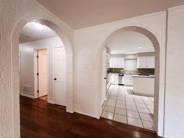 a kitchen with stainless steel appliances kitchen island granite countertop a refrigerator and a stove top oven